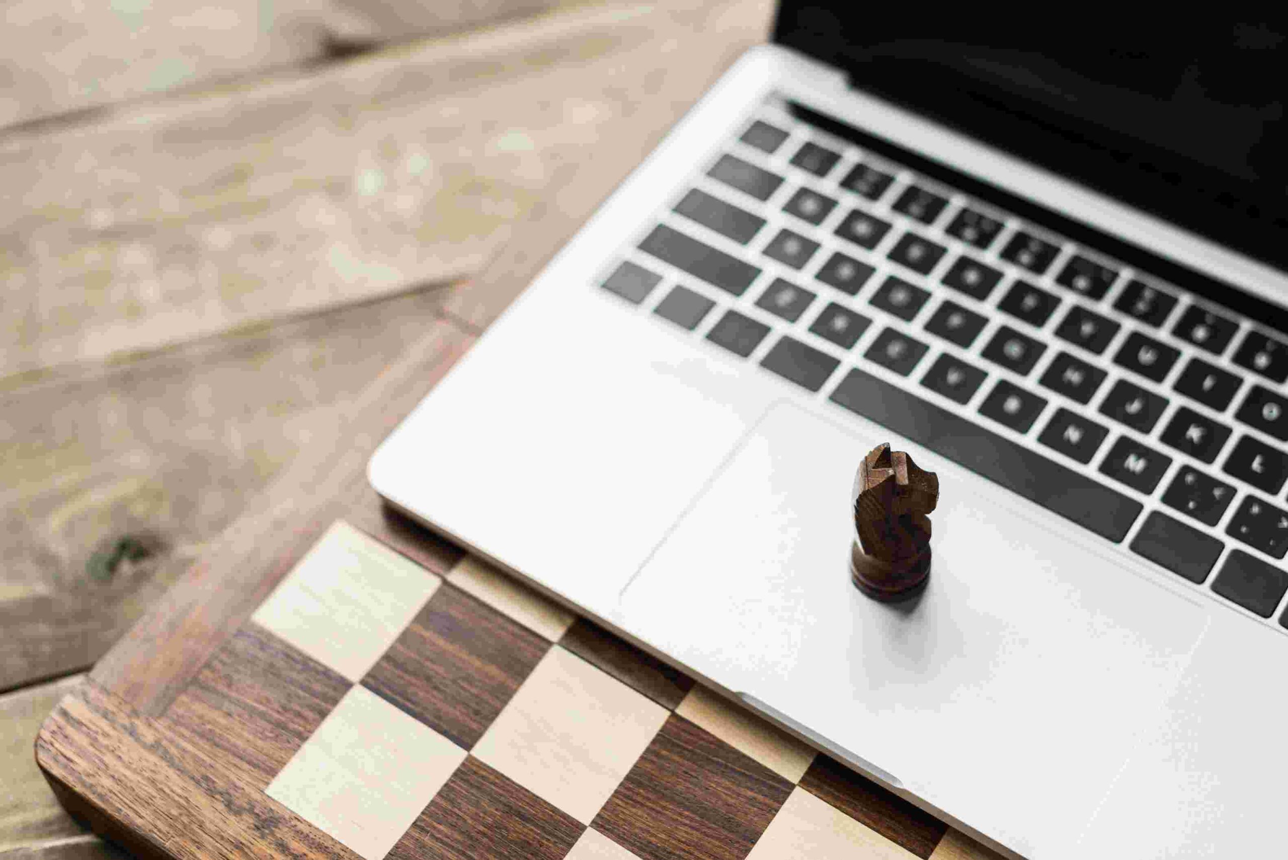 compressed_close-up-of-chess-board-and-laptop-with-chess-figu-2024-11-19-13-50-00-utc